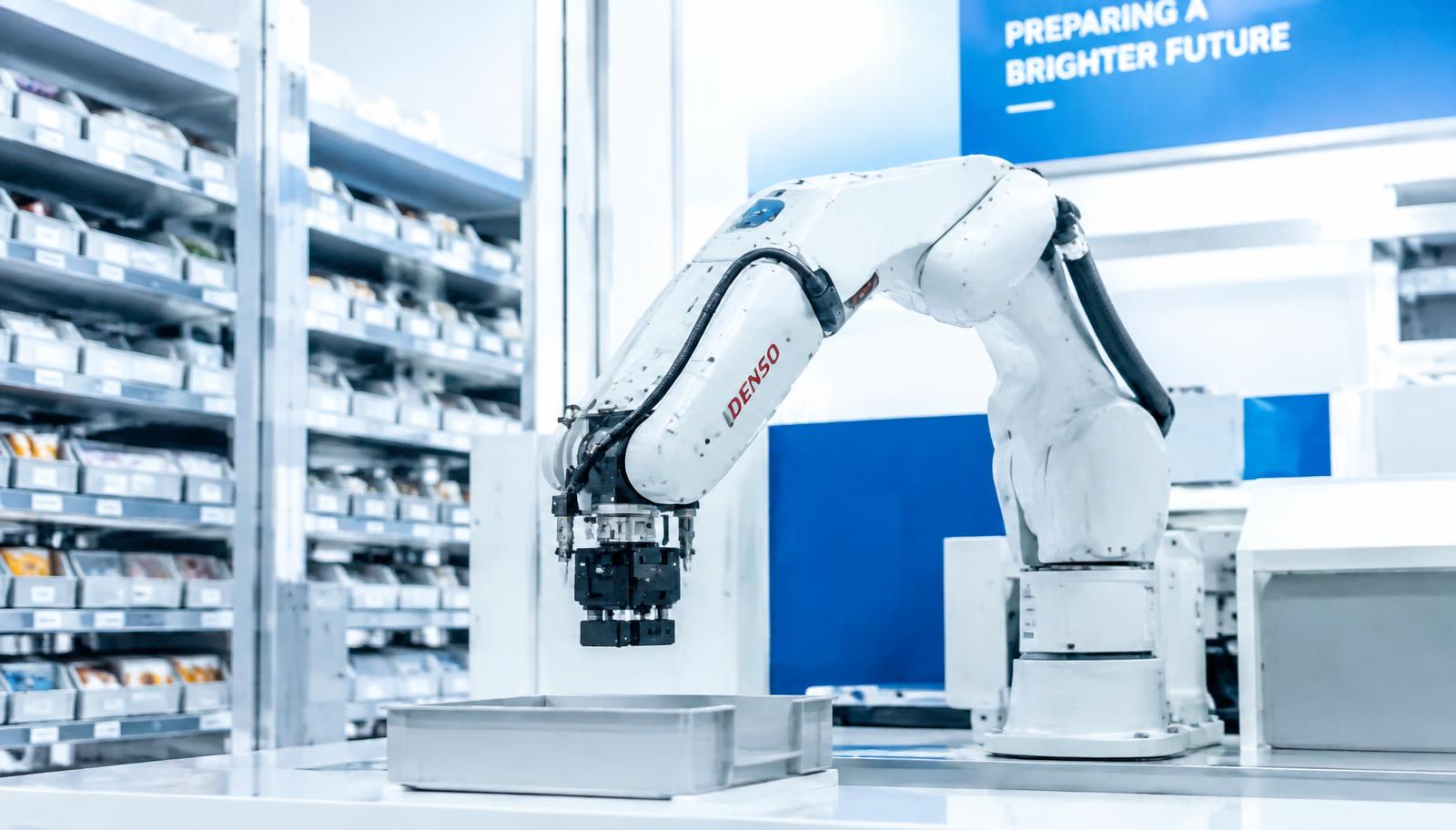 Robotic arm working in a bright automated facility